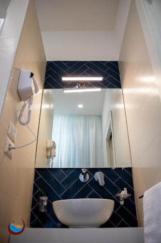 a bathroom with a sink and a mirror at Beauty House Via Veneto in Reggio di Calabria