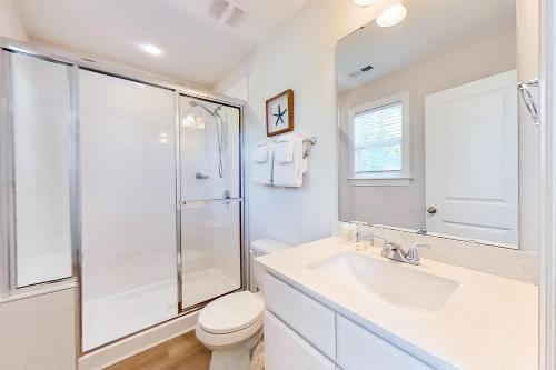 a bathroom with a shower and a sink and a toilet at Downtown Jewel in Wilmington