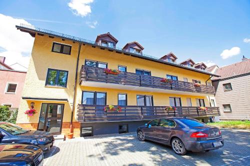 a building with cars parked in front of it at Hotel Post in Weiden