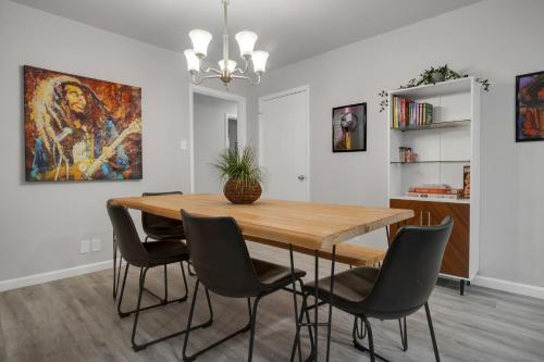 a dining room with a wooden table and chairs at The Harmony Designer Home in Central DFW home in North Richland Hills