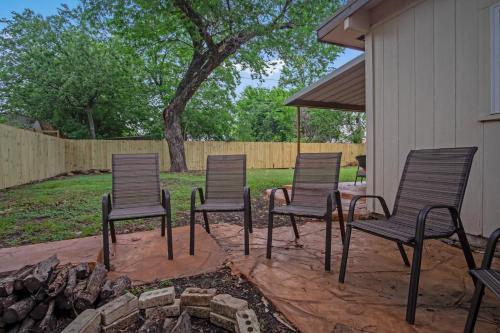 a group of chairs sitting around a fire pit at The Harmony Designer Home in Central DFW home in North Richland Hills