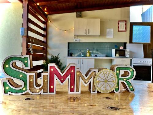 a kitchen with a sign that says summer in a kitchen at PENSIUNEA SCOICA in Costinesti