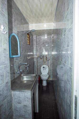 a bathroom with a sink and a toilet at Hostel California in Batumi