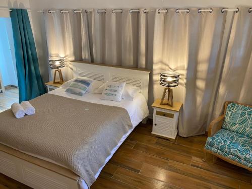 a bedroom with a bed and a chair at Villa de charme avec piscine à 500m des plages in Soorts-Hossegor