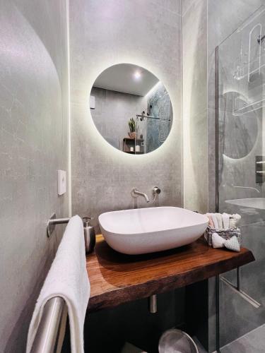 a bathroom with a white sink and a mirror at Residenza Rebecca in Trani