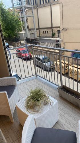a balcony with a table and chairs and a street at Casa Del Duca in Campobasso