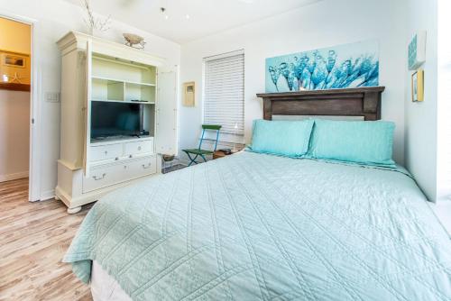 a bedroom with a large bed and a television at Gulfview II 301 in Destin
