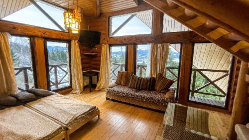 a living room with large windows and a couch at Casa del Pozitiff in Slavske