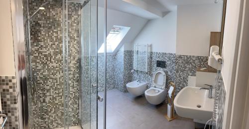 a bathroom with a shower and a toilet and a sink at Main-Apartments in Wertheim