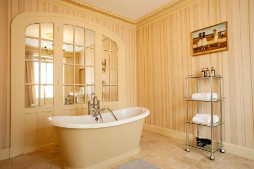 La grande salle de bains est pourvue d'une baignoire et d'une fenêtre. dans l'établissement Les Cordeliers, à Sarlat-la-Canéda