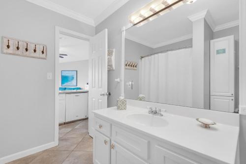 a white bathroom with a sink and a mirror at Gulfview II 318 in Destin