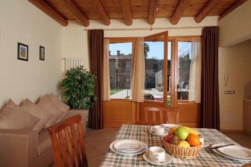 a living room with a table with fruit on it at Residence Borgo Mondragon in Lazise