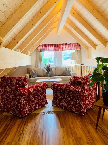 a living room with two chairs and a couch at Bergheimat in Bad Goisern