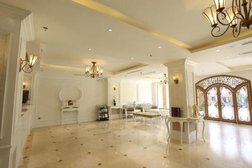 a large living room with chairs and a table at CityBay Palace Hạ Long Hotel in Ha Long