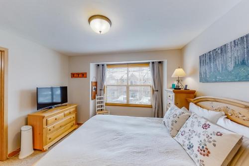a bedroom with a bed and a television at Saw Mill Station 127 in Winter Park