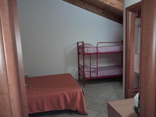 a bedroom with two bunk beds and a table at B&B Gege' in Roccadaspide