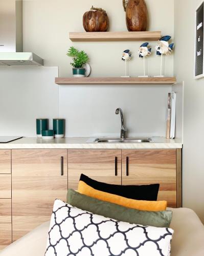 a kitchen with wooden cabinets and a sink at VILA 8 in Himare