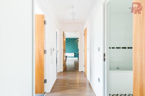 a hallway of a home with white walls and wood floors at Granville Street - Spacious 2 Bedroom Apartment Birmingham City Centre in Birmingham