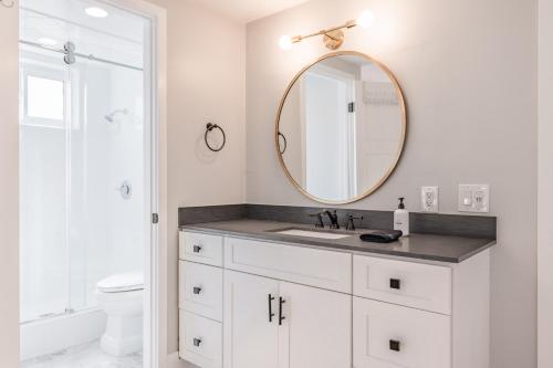 a bathroom with a sink and a mirror at @ Marbella Lane - Modern and Luxurious Design Home in Fullerton