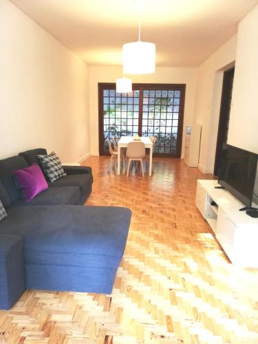 a living room with a blue couch and a table at Lisboa Central Apartment in Lisbon