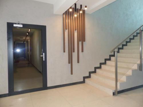 a hallway with a stairway with a stairway at Aquarius Holiday Boszkowo Apartamenty in Boszkowo