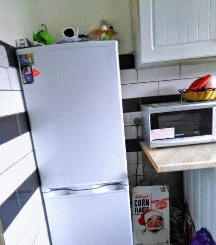 a white refrigerator in a kitchen next to a microwave at Comfortable double bedroom in London in Hornchurch