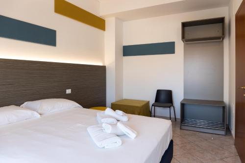 a hotel room with a bed with towels on it at Smart and Sea in Tortoreto Lido