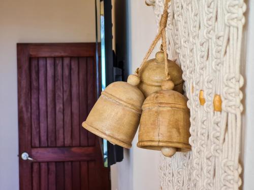 two bells hanging on a wall next to a door at STYLISH OCEANFRONT CONDO with POOL in Mahahual