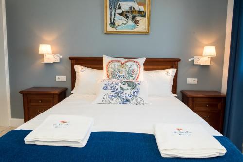 a bedroom with a bed with white sheets and pillows at Quinta da Paz in Caniço