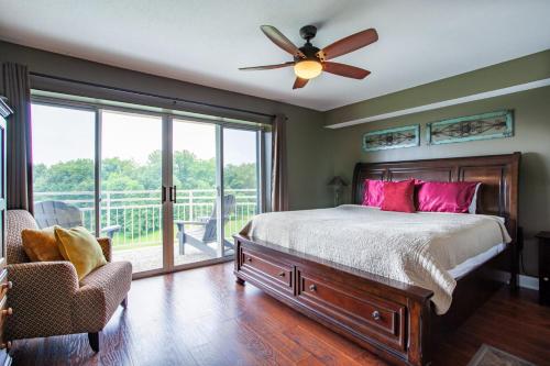 a bedroom with a bed and a ceiling fan at Penthouse Paradise - Fireplace and Mountain View in Pigeon Forge
