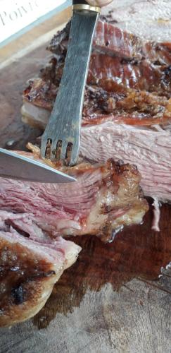 a knife sitting on top of a bunch of meat at Base Manzano in Tunuyán