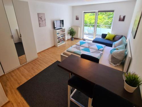 a living room with a couch and a table at Apartment am Gradierbau Bad Kissingen in Bad Kissingen