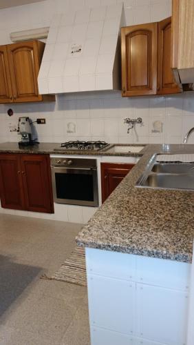 a kitchen with a sink and a counter top at Lumera in Santa Flavia