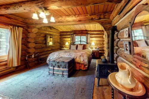a bedroom with a bed in a log cabin at Durango Dreams in Durango