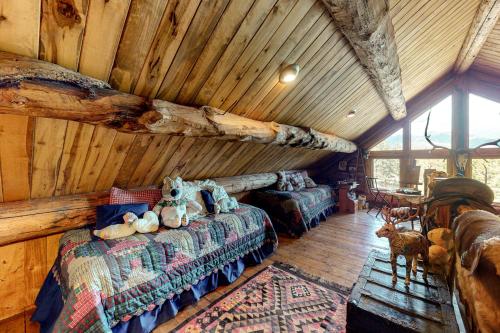 a log cabin bedroom with a bed and a table at Durango Dreams in Durango