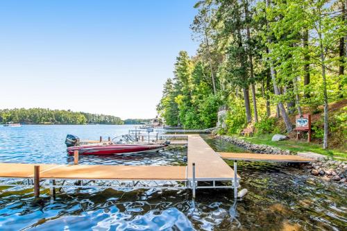 a dock with a boat on a lake at Lake Minocqua Lakeview in Minocqua