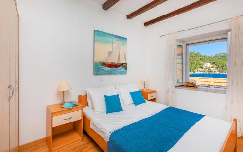 a bedroom with a bed and a window at Apartments Daniela & Karlo in Sobra