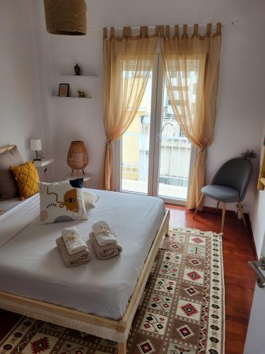 a bedroom with a bed with two towels on it at Viva La Veranda Apartment in Central Athens in Athens