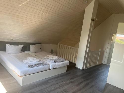 a bedroom with a white bed with towels on it at Ferienhaus Muschel in Kalkhorst