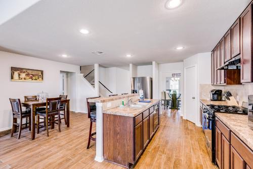 a kitchen with wooden floors and a dining room with a table at Foxwood Mist in Humble