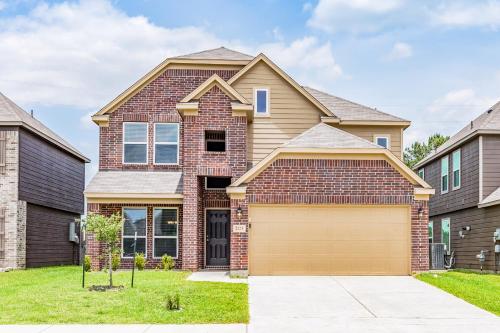 a brick house with a garage at Foxwood Mist in Humble