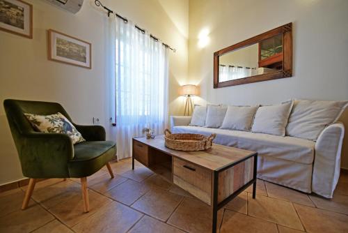 a living room with a couch and a chair at Unique luxury suites in Hydra