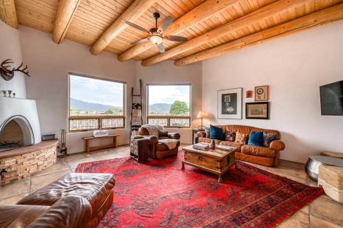 a living room with leather furniture and a fireplace at Casa De Los Conejos in El Prado