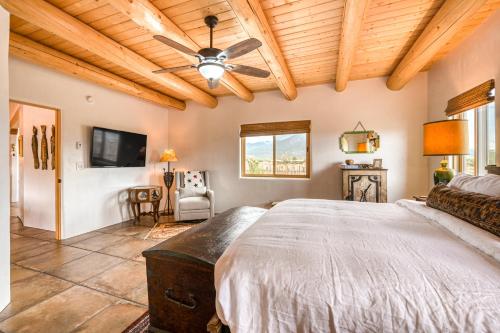 a bedroom with a bed and a ceiling fan at Casa De Los Conejos in El Prado