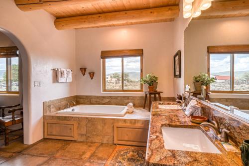 a large bathroom with a tub and a sink at Casa De Los Conejos in El Prado