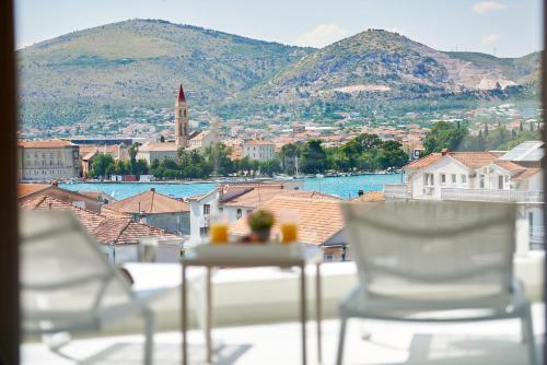 two chairs and a table with a view of a city at Villa Trogir 2 in Trogir