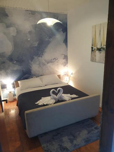 a bedroom with a bed with a ribbon on it at Apartman_trile in Ulcinj