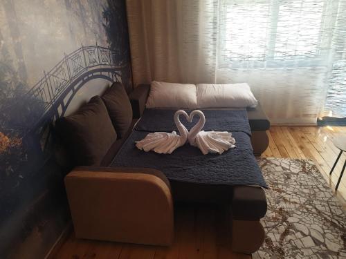 a bedroom with two beds with swans on them at Apartman_trile in Ulcinj