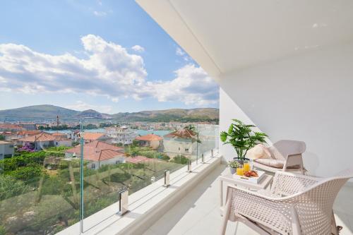 a balcony with white furniture and a view of the city at Villa Trogir 2 in Trogir