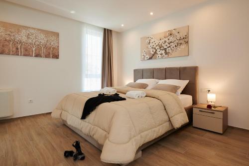 a bedroom with a large bed in a room at Villa Trogir 2 in Trogir